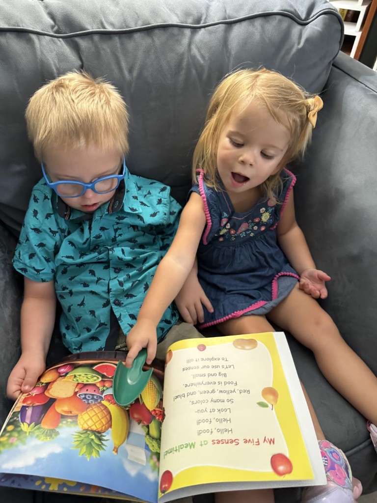 Two children reading My Five Senses at Mealtime together